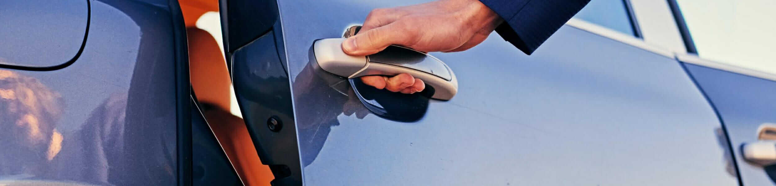 Chauffeur opening the limo door for a casino guest — designated driver service Kenosha