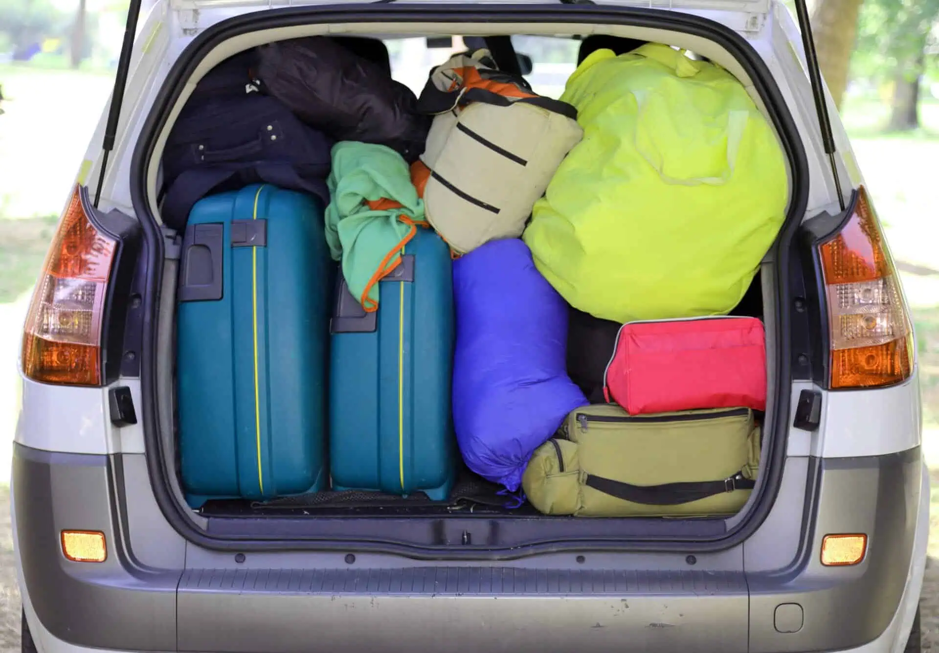 car and plenty of luggage and suitcases when leaving for family summer holidays