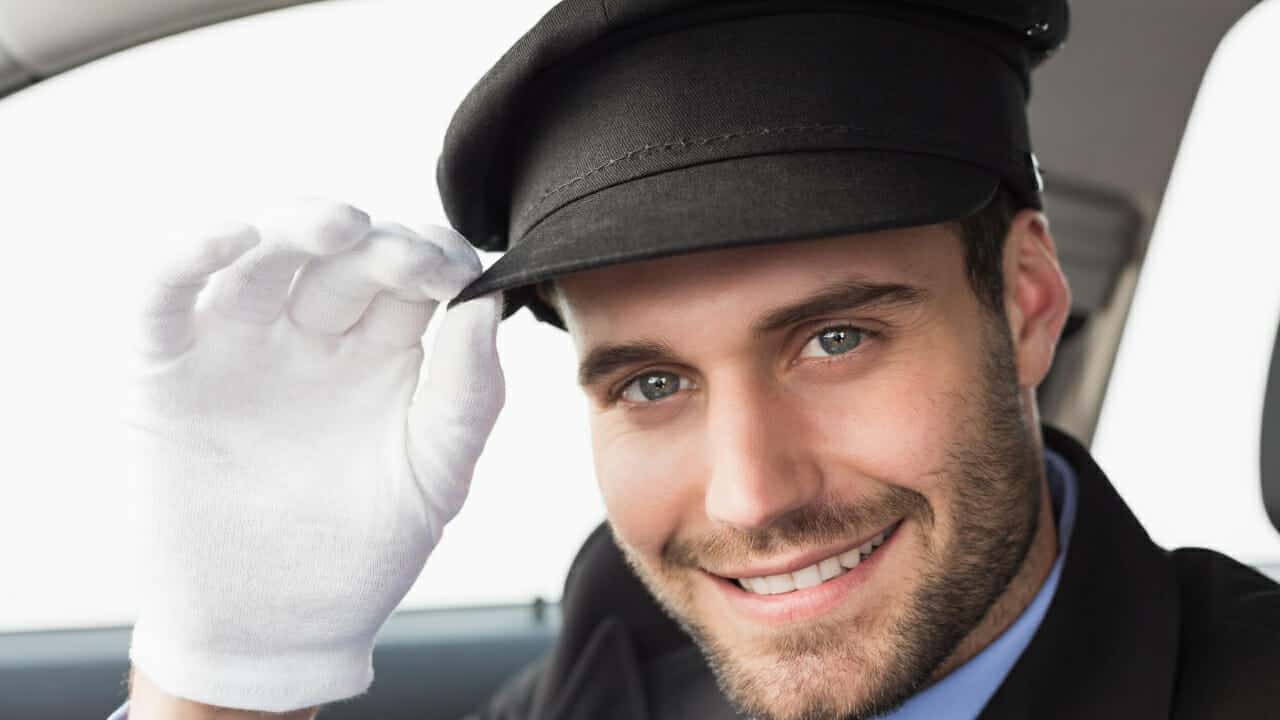 Professional chauffeur assisting family members — funeral transportation service