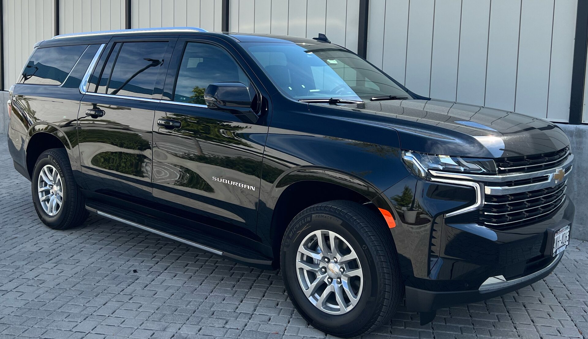 Contact Limo Chevy Suburban fleet side profile — professional chauffeur SUV Kenosha