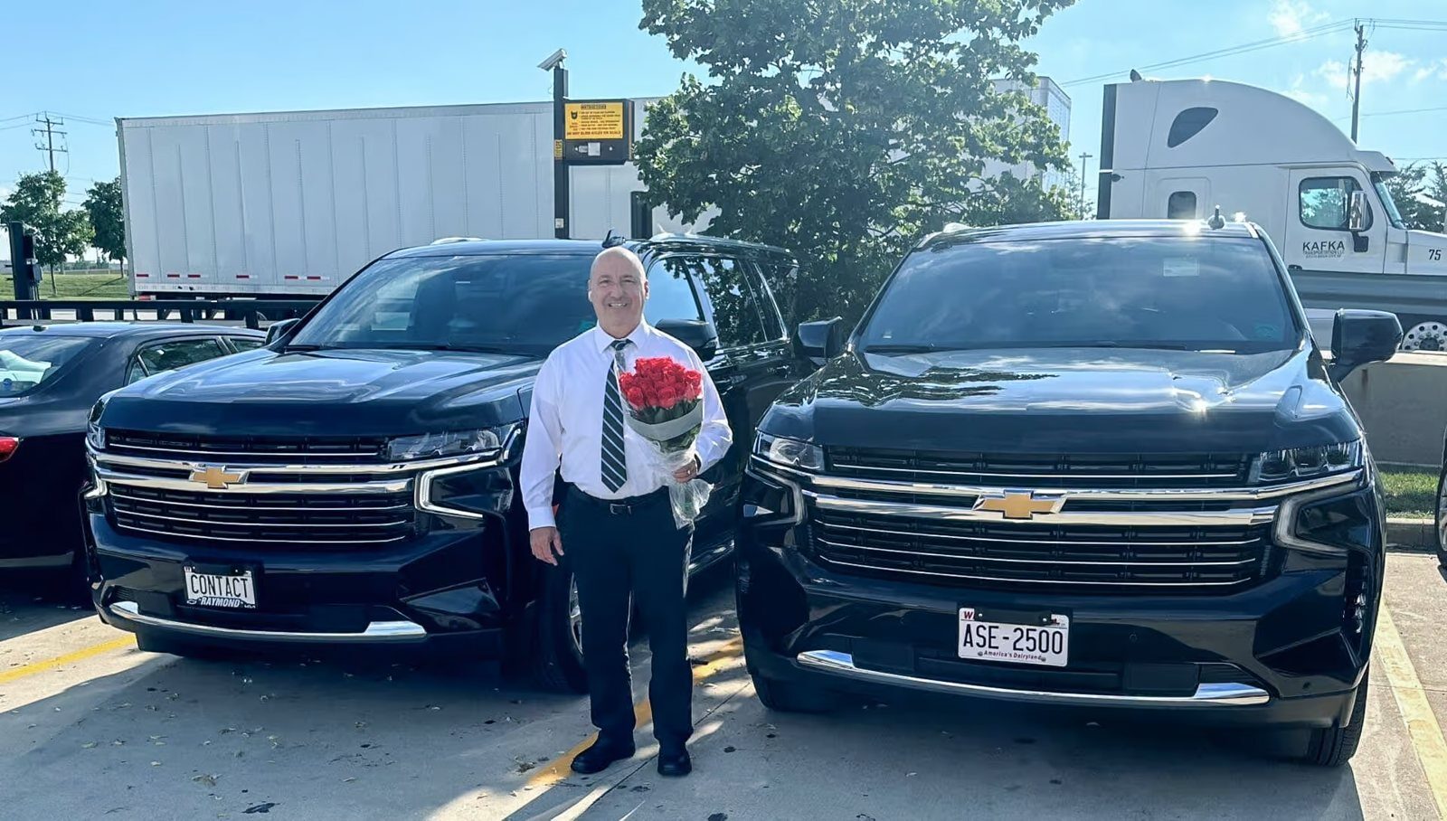 Contact Limo owner Lucian Muresanu with fleet vehicle and roses — Kenosha Wisconsin wedding transportation