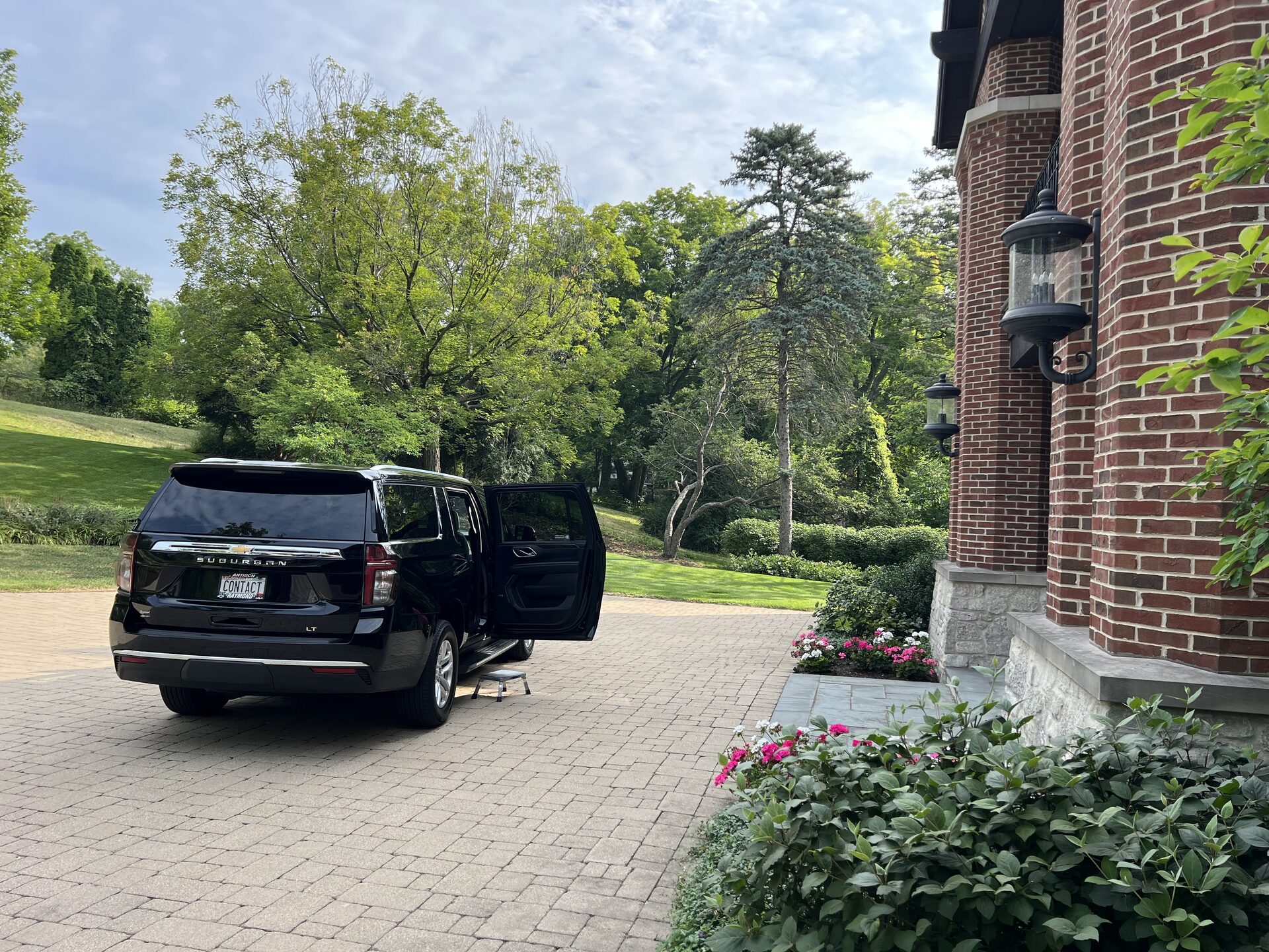 Contact Limo SUV door open at brick estate for bridal party pickup Wisconsin