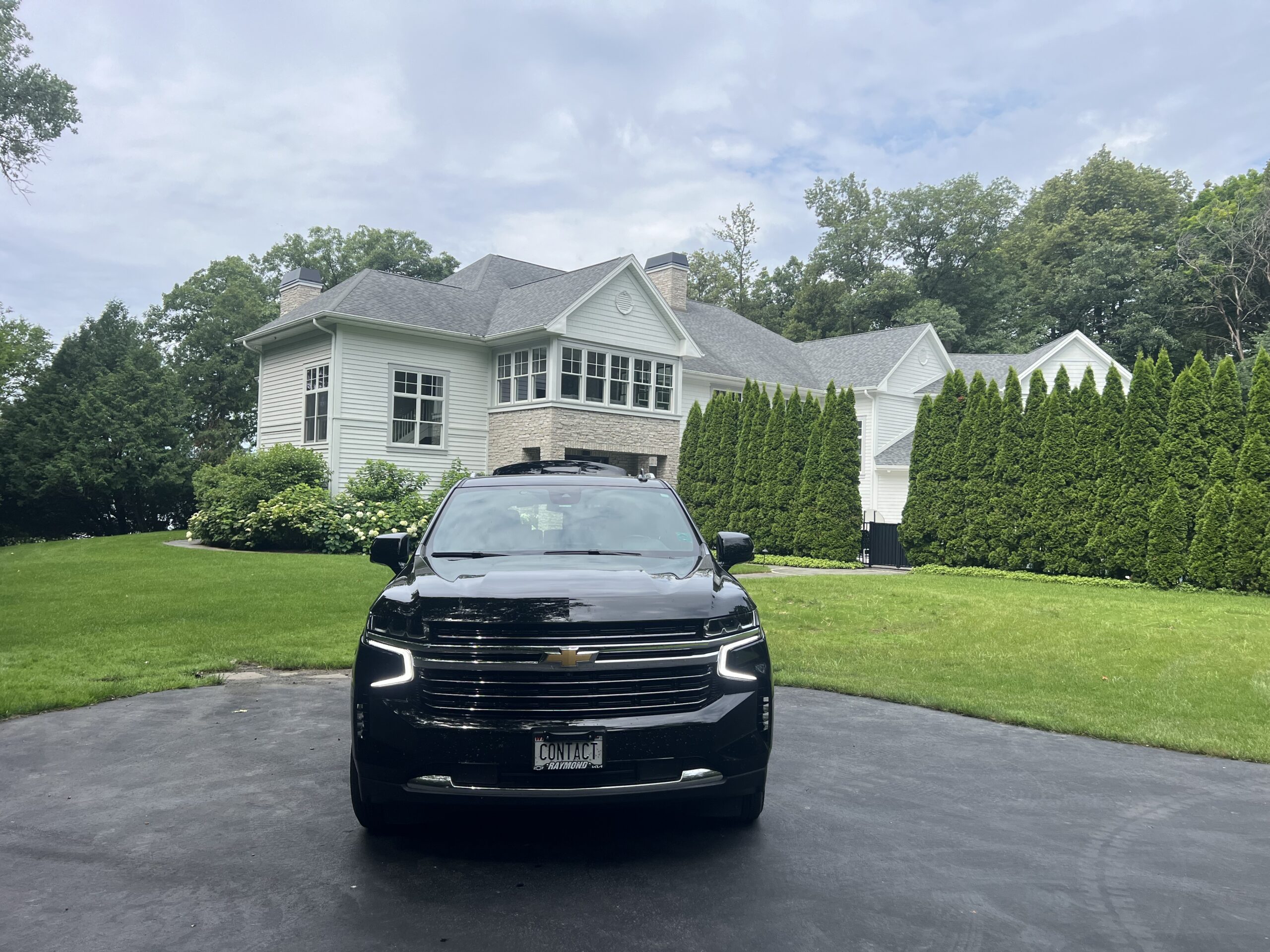 Contact Limo LLC luxury SUV front view at Elkhorn WI estate — golf and event limo service