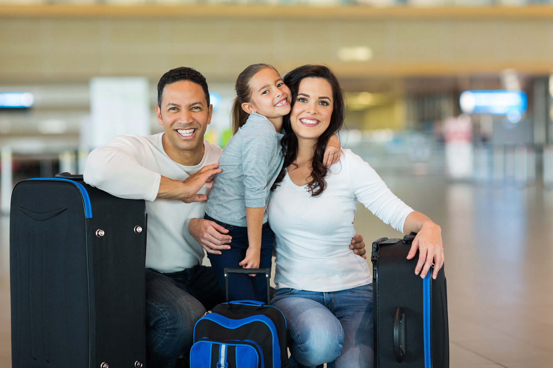 Family with luggage at airport terminal — Contact Limo out-of-town family transportation Kenosha Wisconsin