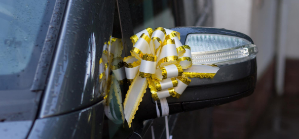 Gold ribbon bow on black SUV mirror — Contact Limo wedding vehicle decoration Kenosha Wisconsin