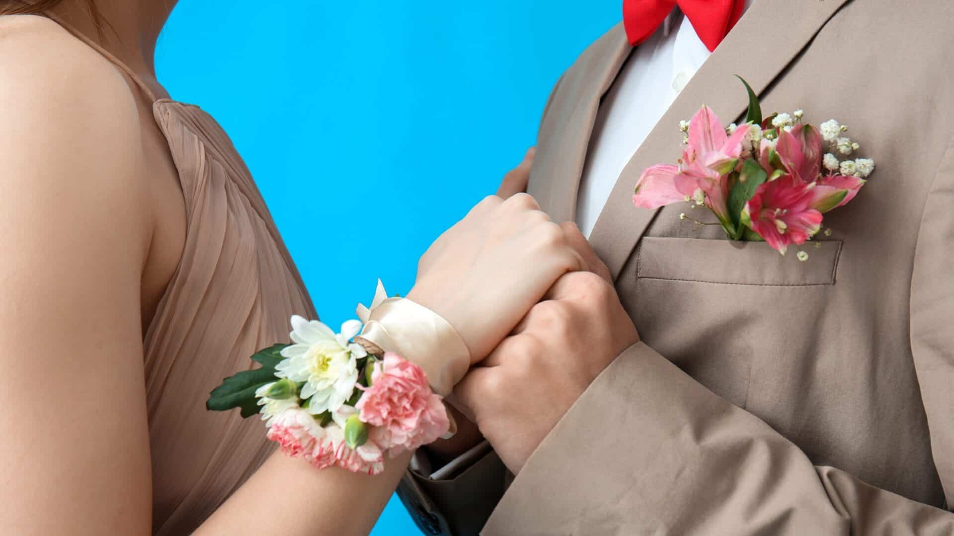 Prom couple with corsage and boutonniere before their limo arrives