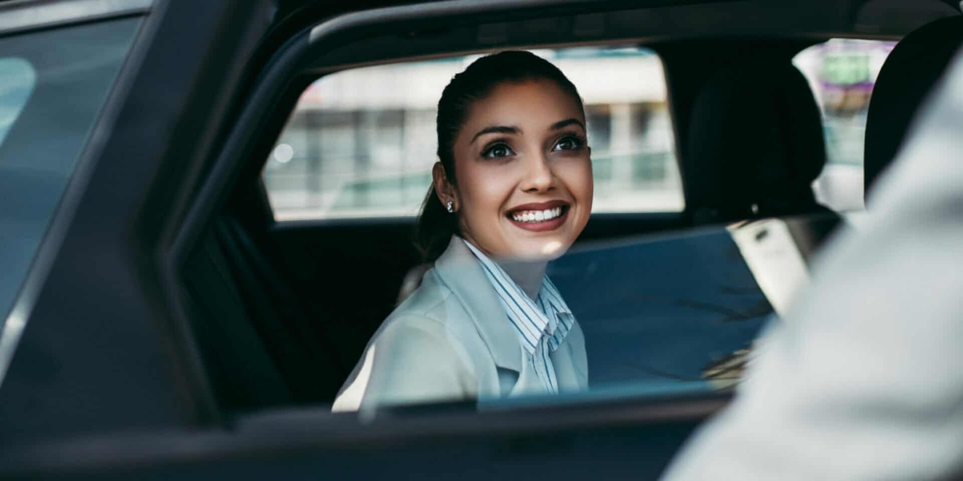 Passenger relaxing in the back seat on a long-distance point-to-point ride